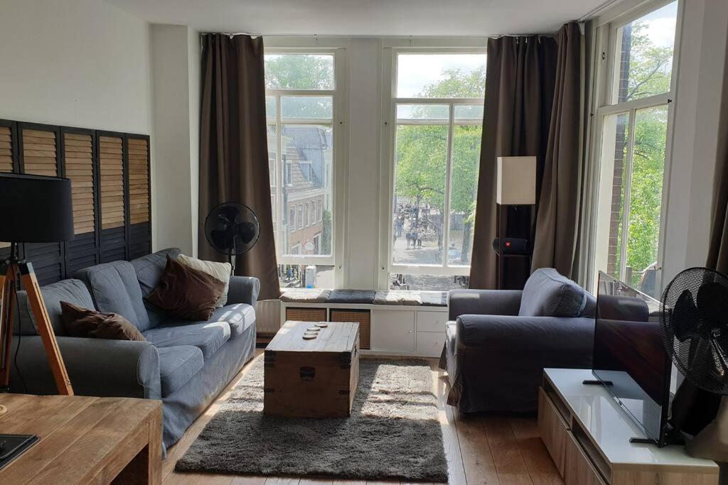 a living room with a couch and a table at Amsterdam - Bright, canal-side, central, renovated 1BR in Amsterdam