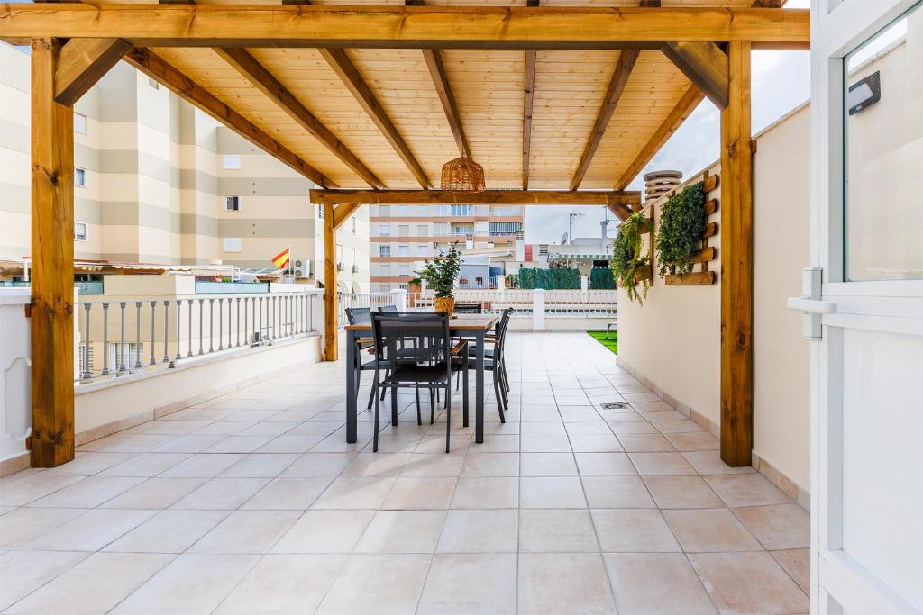 a patio with a table and chairs on a balcony at A&N Mar 3 in Torre del Mar