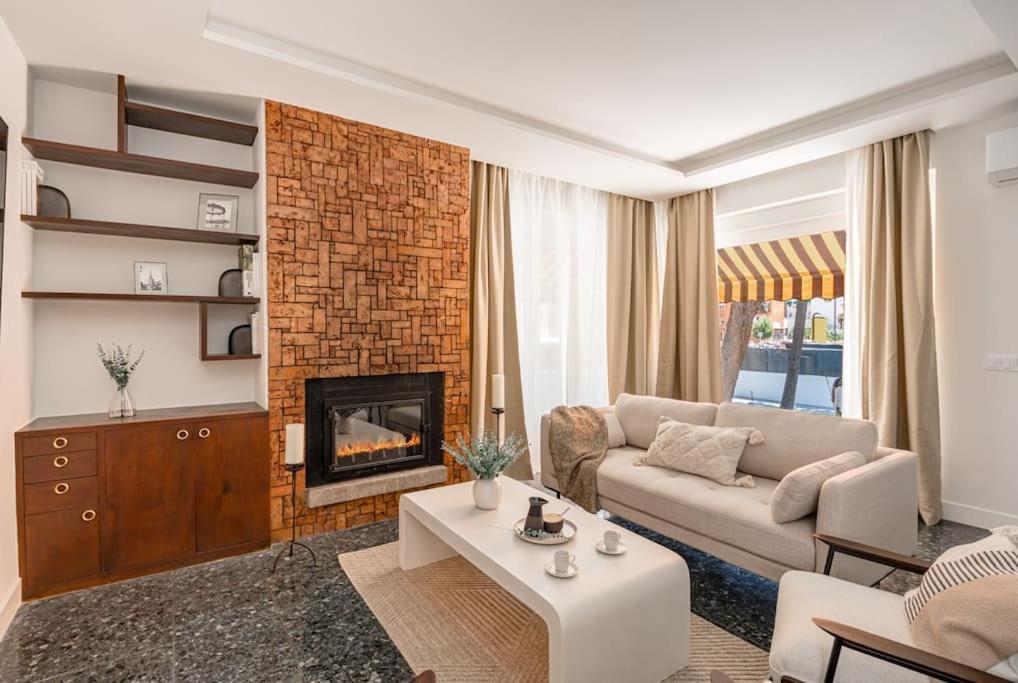 a living room with a couch and a fireplace at Chalet de lujo 'LA CASA DE INÉS' in Alcalá de Henares