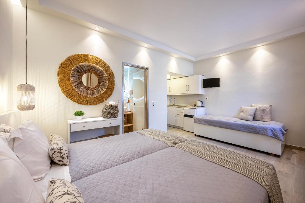 a bedroom with a large bed and a mirror at Panorama Studios in Mastichari
