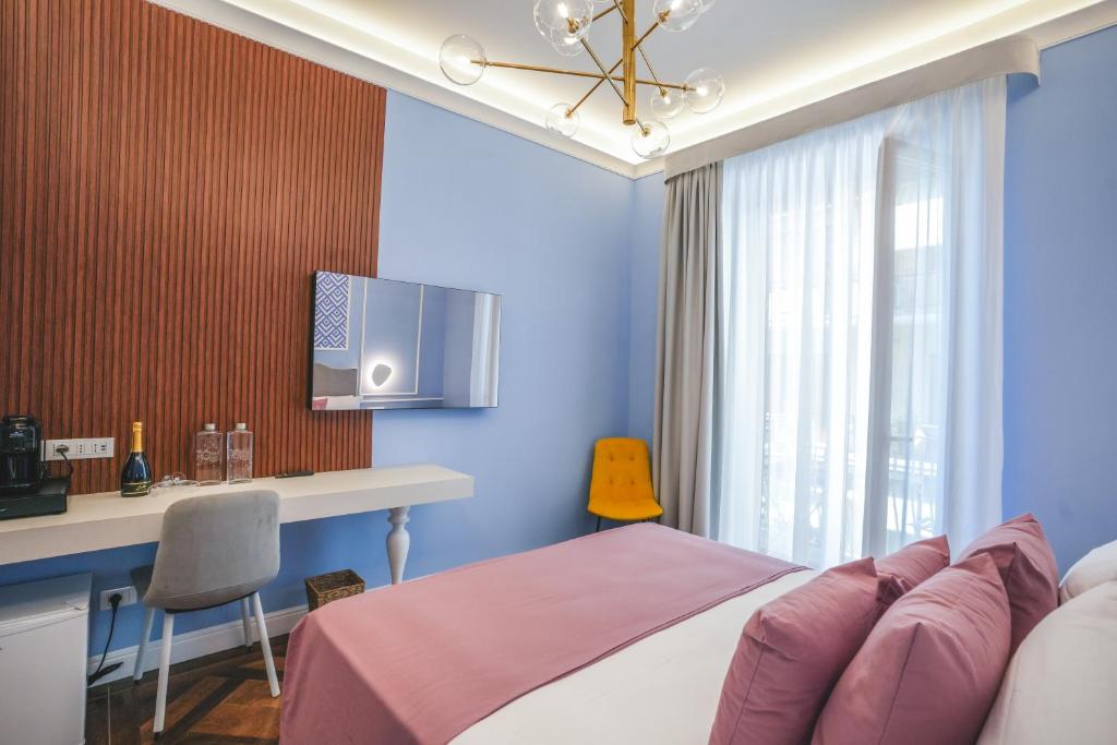 Postel nebo postele na pokoji v ubytování Cafè Latino Suites