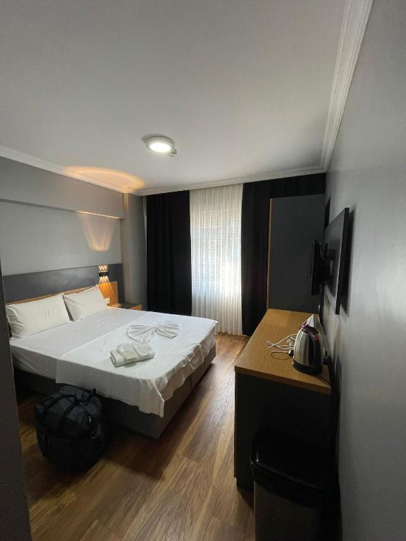 A bed or beds in a room at Hotel Otağ