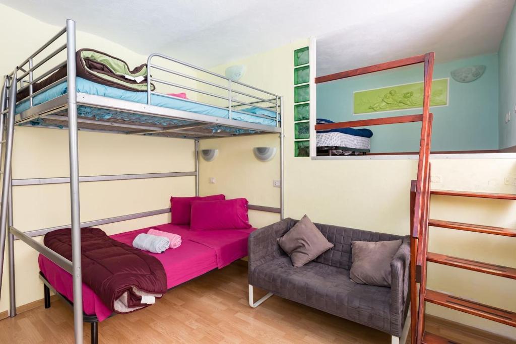 a bedroom with a bunk bed and a couch at Holiday House Esedra in Rome