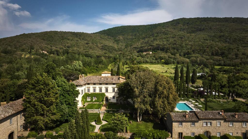 an aerial view of a mansion in the mountains at Villa di Piazzano - Small Luxury Hotels of the World in Cortona