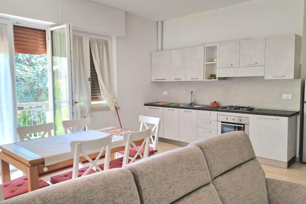 a living room with a couch and a table and a kitchen at S.Benedetto Terrace apartment in Peschiera del Garda