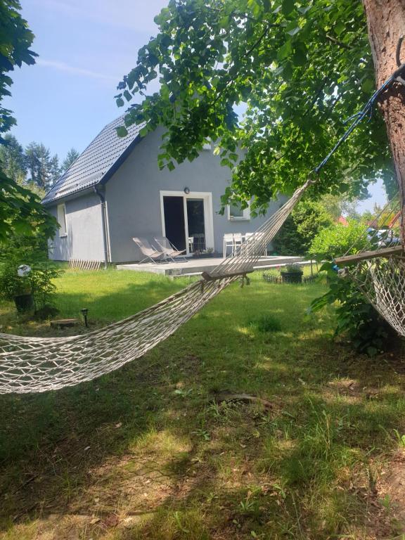 a hammock in front of a house at Siedlisko na Ustroniu in Sasino