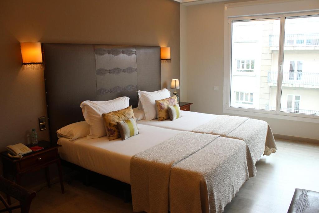 Postel nebo postele na pokoji v ubytování Hotel Ciudad de Vigo