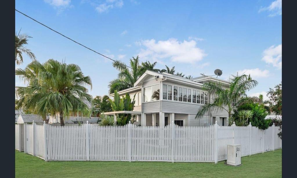 a white fence in front of a white house at Sturges Street 22 - Unit 1 in Aitkenvale