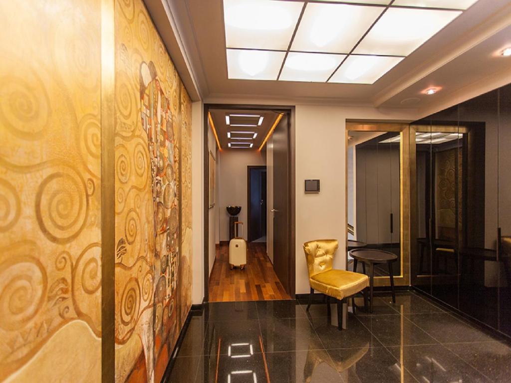 a hallway of an office with a chair and a table at Soleil Boutique H in Sopot