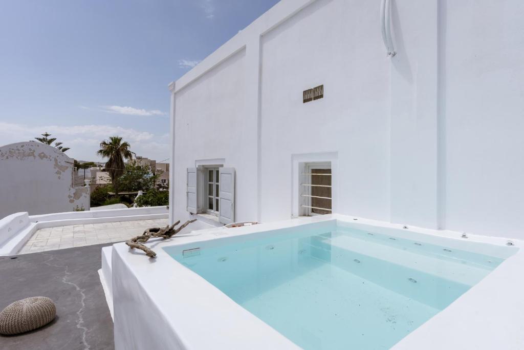 a swimming pool in the middle of a house at On An Island suites & apartments - Fira in Fira