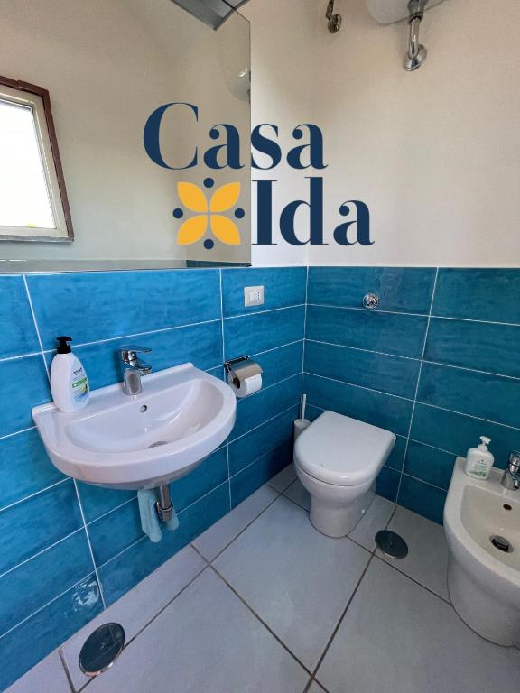 a bathroom with a sink and a toilet and a sign at Amalfi Coast Casa Ida in Vietri sul Mare