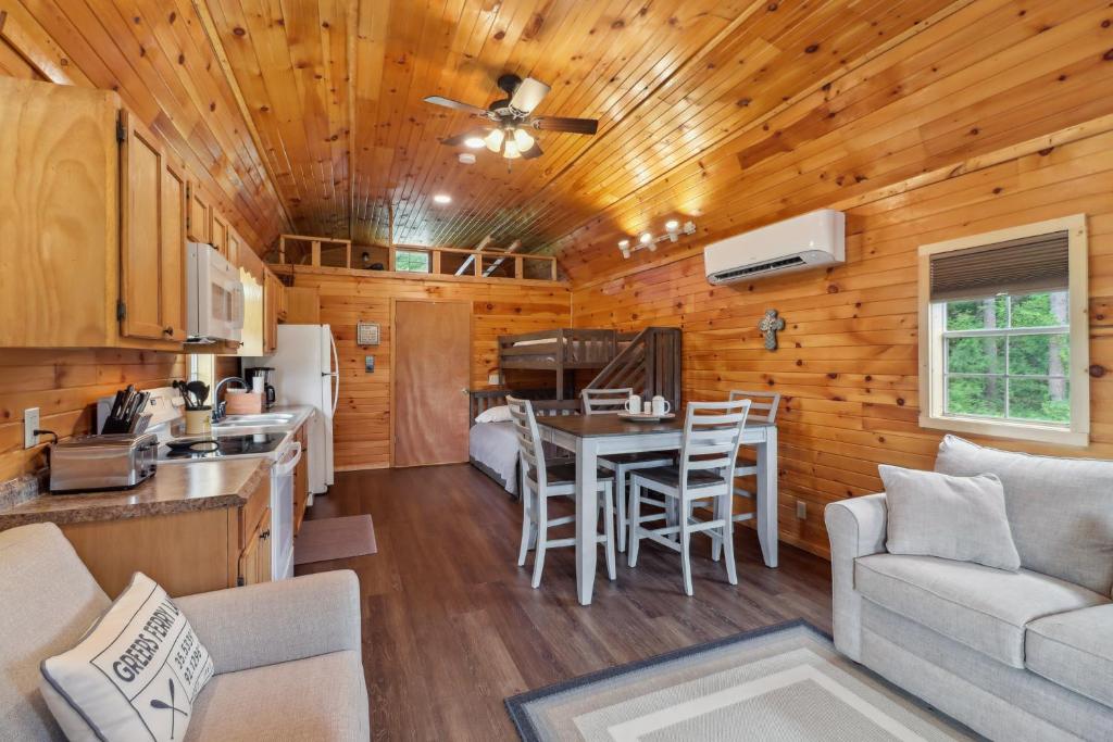 a kitchen and living room in a log cabin at Higden Hideaway with Fire Pit Near Greers Ferry Lake in Fairfield Bay