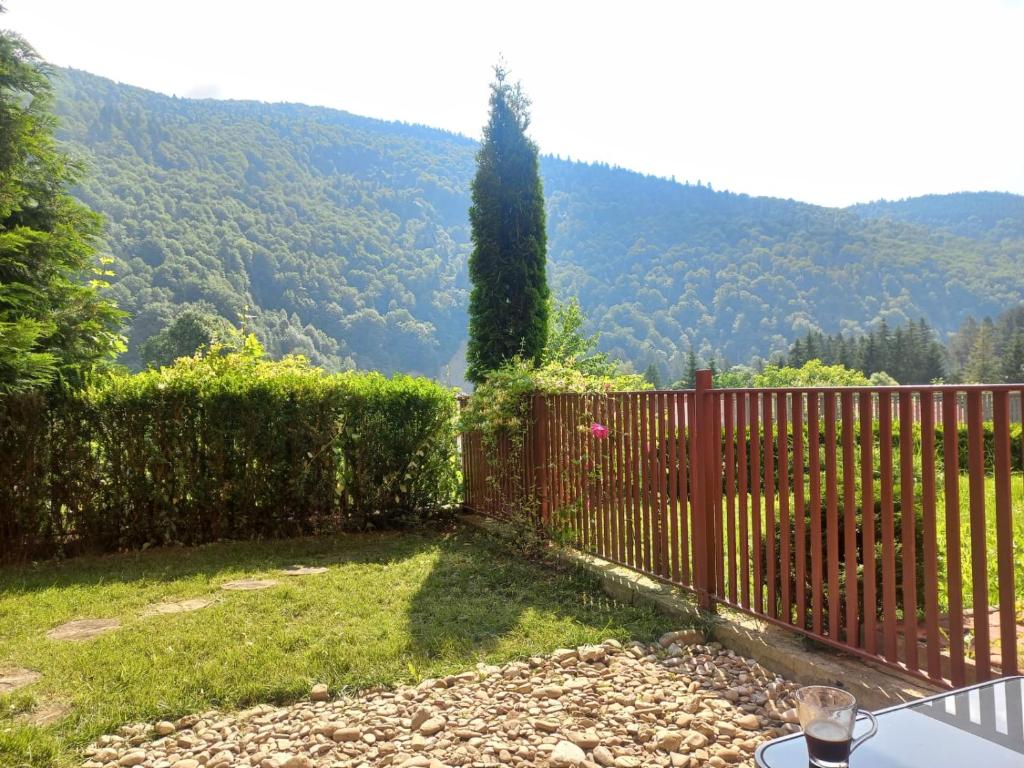 a red fence with a view of a mountain at WWA SUNLIGHT VIBES in Sinaia