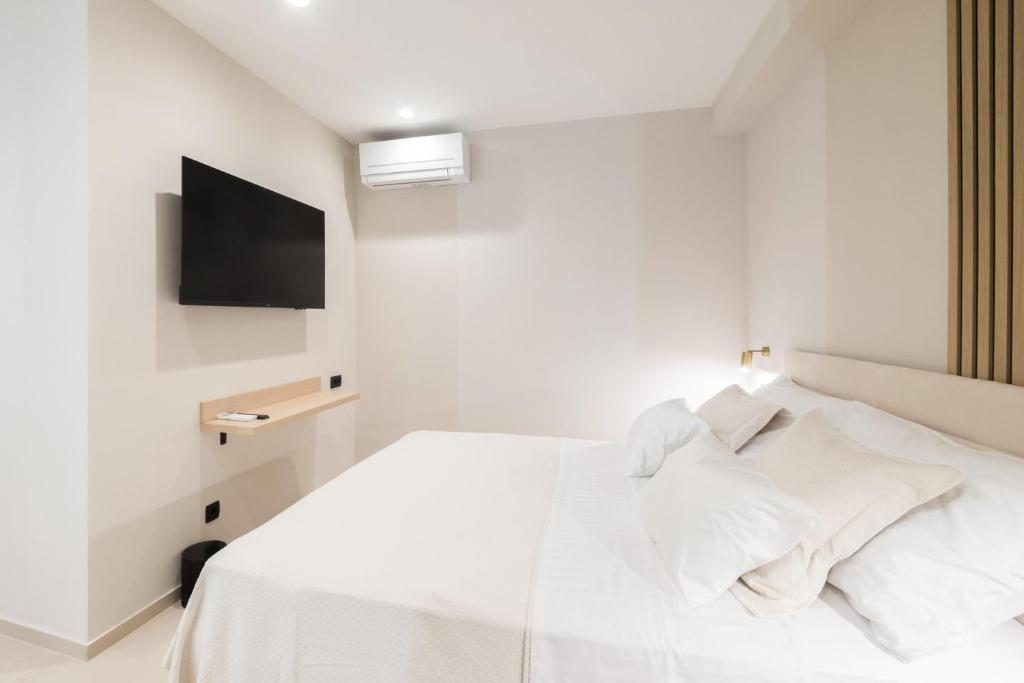 Postel nebo postele na pokoji v ubytování Tonio Rooms