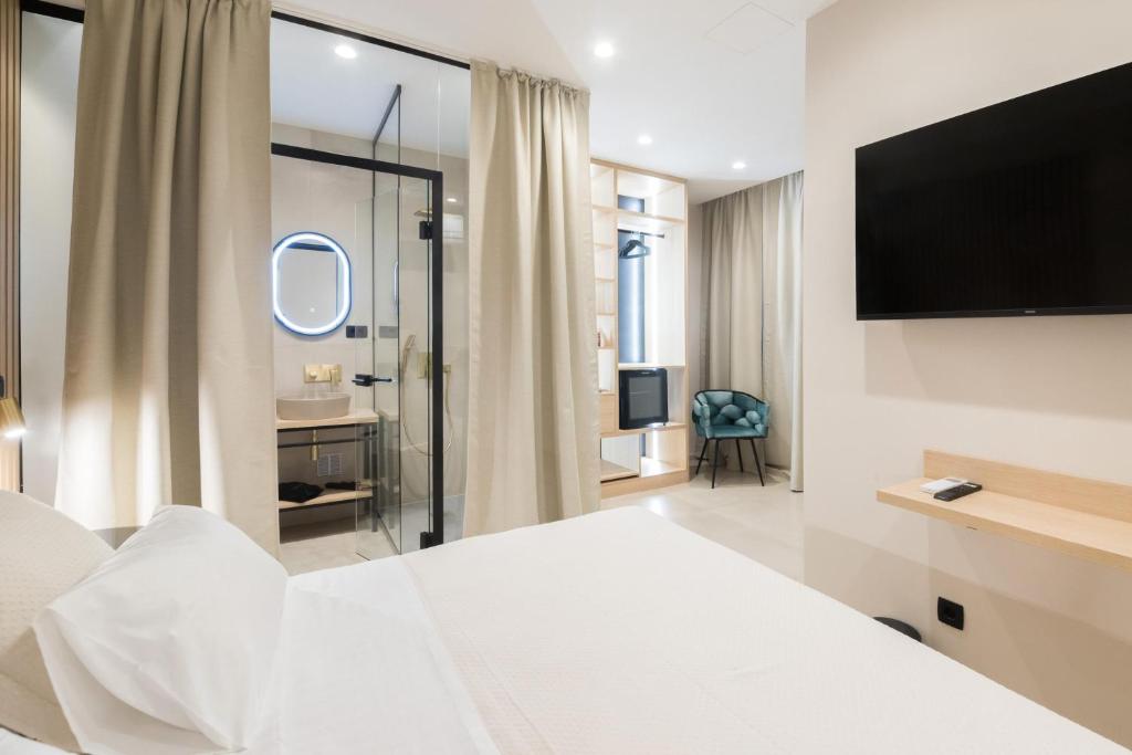 Postel nebo postele na pokoji v ubytování Tonio Rooms