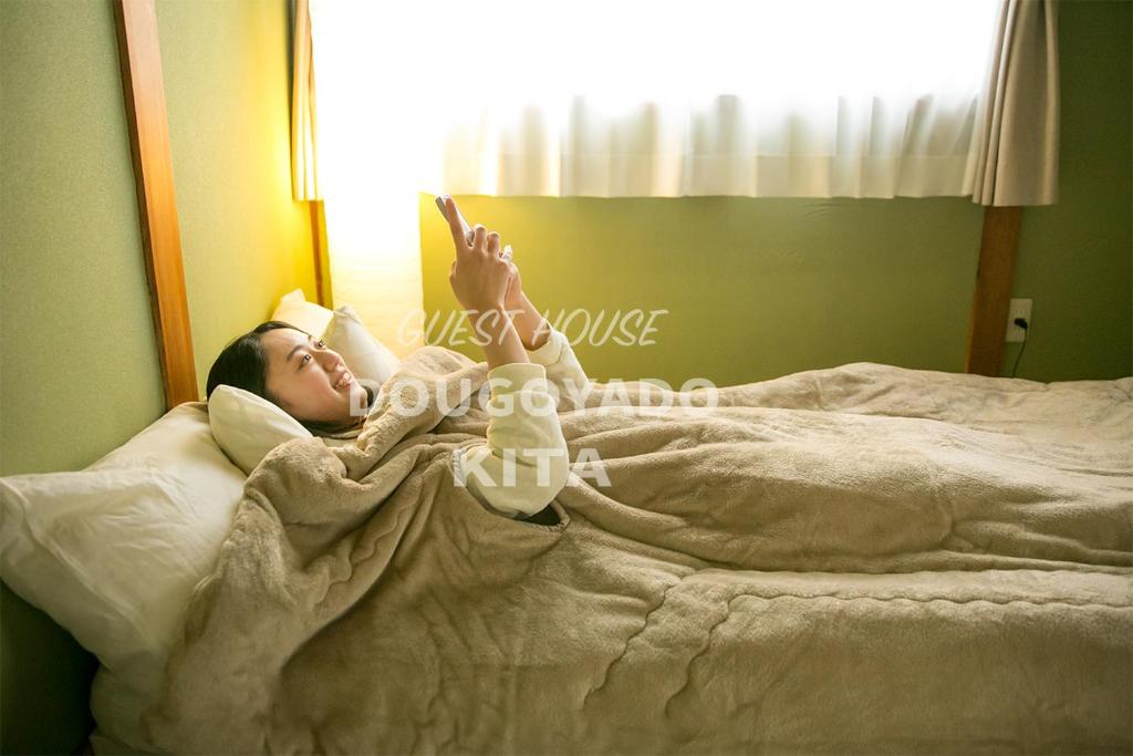 Postel nebo postele na pokoji v ubytování GUEST HOUSE DOUGOYADO KITA