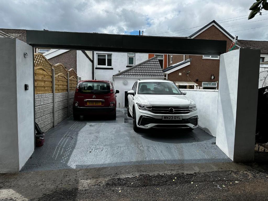 a garage with a car parked in a driveway at Clare Street - 3 bedroom house with private parking in Merthyr Tydfil