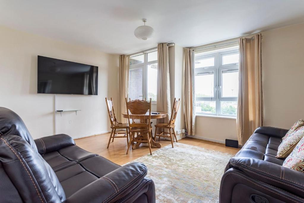 a living room with a couch and a table at Home From Home in London