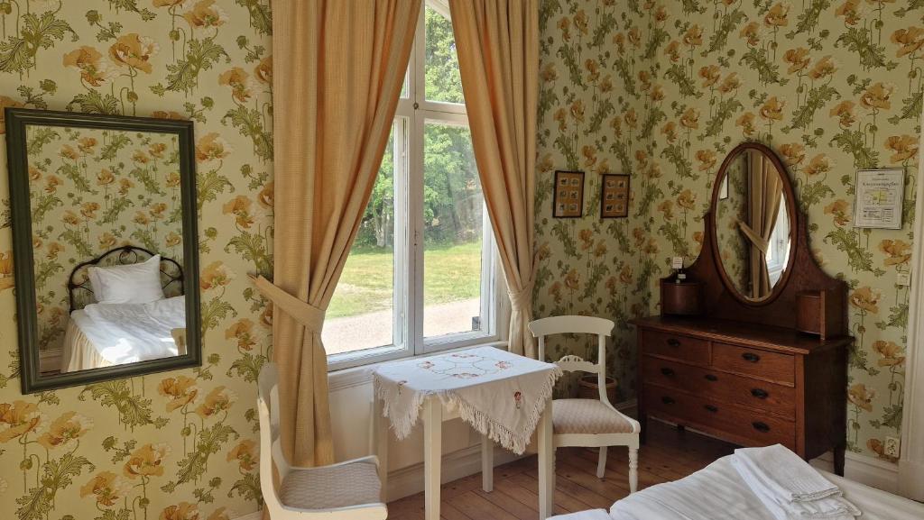 Postel nebo postele na pokoji v ubytování Nääs Slott