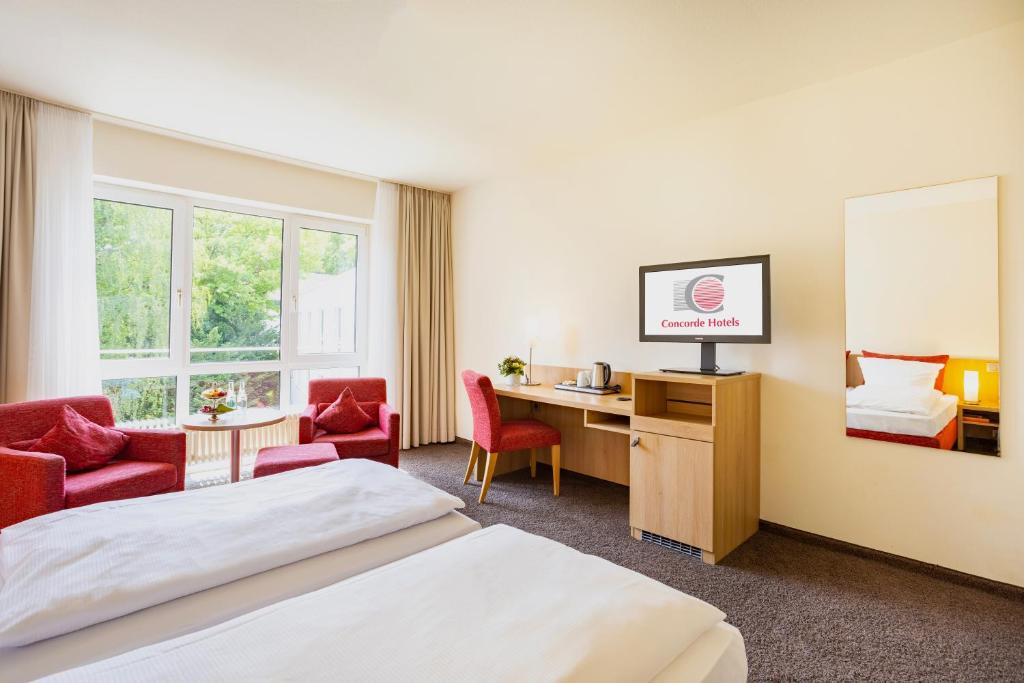 TV a/nebo společenská místnost v ubytování Concorde Hotel Viktoria