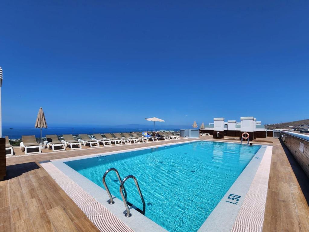 a swimming pool with a view of the ocean at Chill Out Tesoro in Adeje