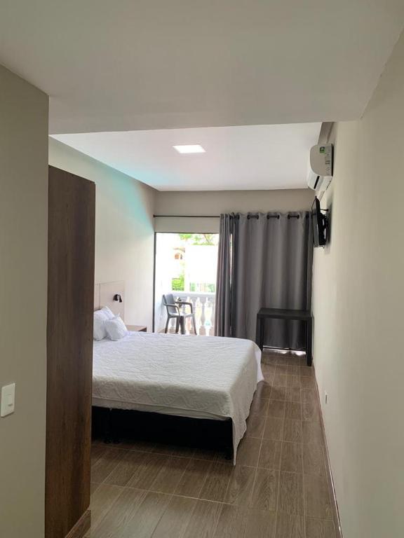 Postel nebo postele na pokoji v ubytování HOTEL MELGAR PLAZA