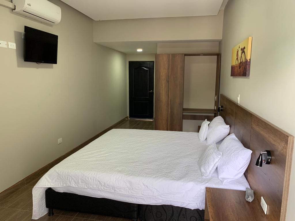 Postel nebo postele na pokoji v ubytování HOTEL MELGAR PLAZA