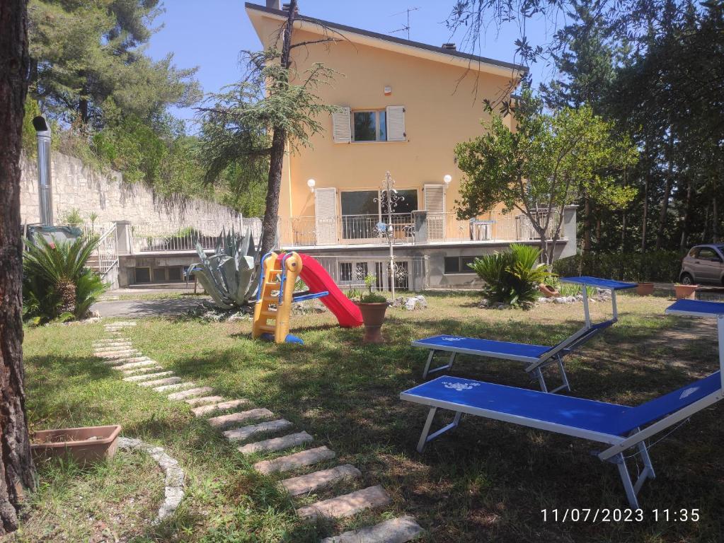 een tuin met speeltoestellen en een huis bij Parco dei Gelsomini in Ascoli Piceno