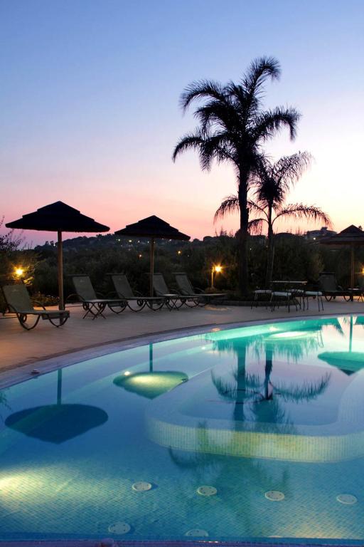 a swimming pool with a person standing in the water at Hotel Santa Chiara in Capo Vaticano
