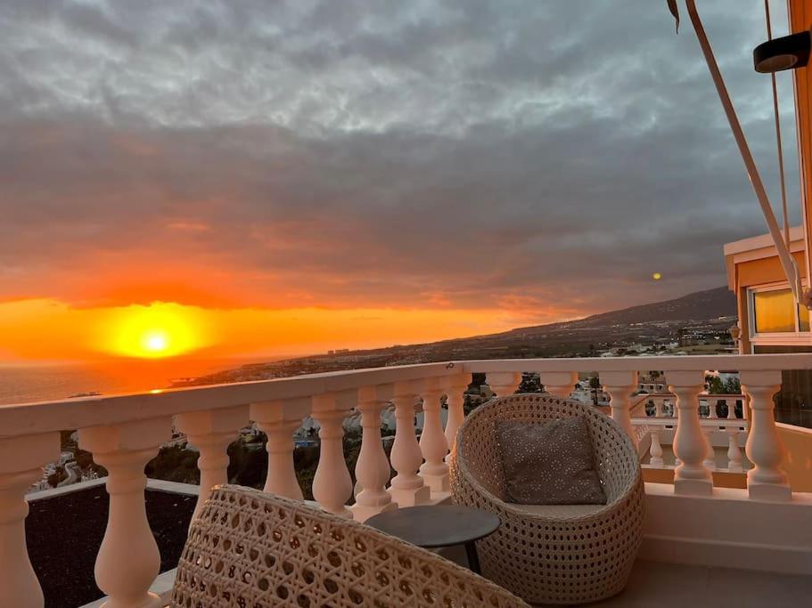 a balcony with a view of the ocean at sunset at Sunset Terrace Ocean View in Adeje