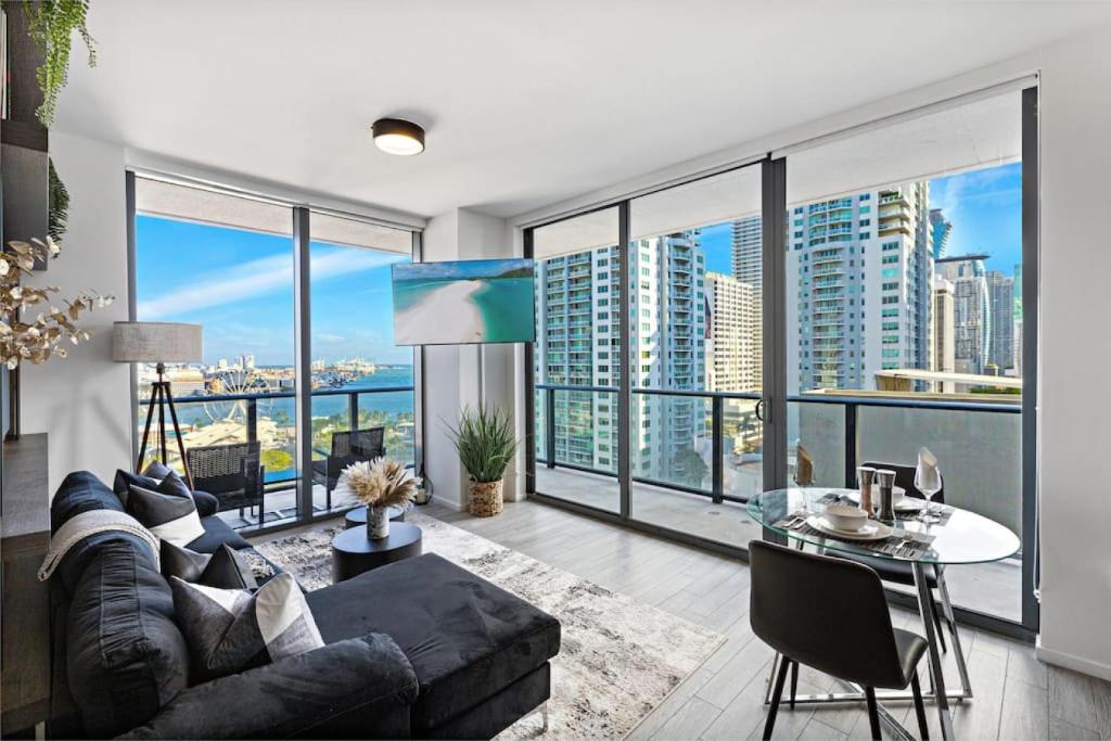 a living room with a couch and a table at Corner condo w/ Unrivaled views in Miami