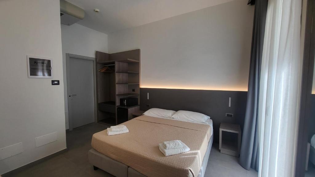 Postel nebo postele na pokoji v ubytování Hotel Giannini