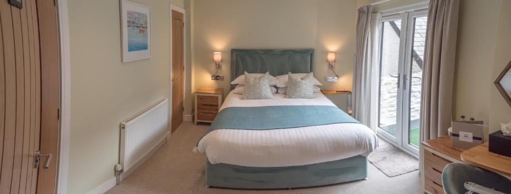 a bedroom with a large bed and a window at Waterfront House in Dartmouth