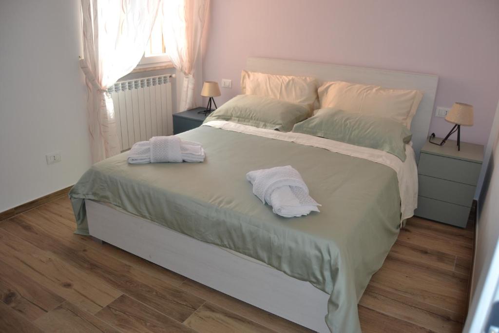 a bedroom with a bed with two towels on it at Apartment Bellavista in Pisa