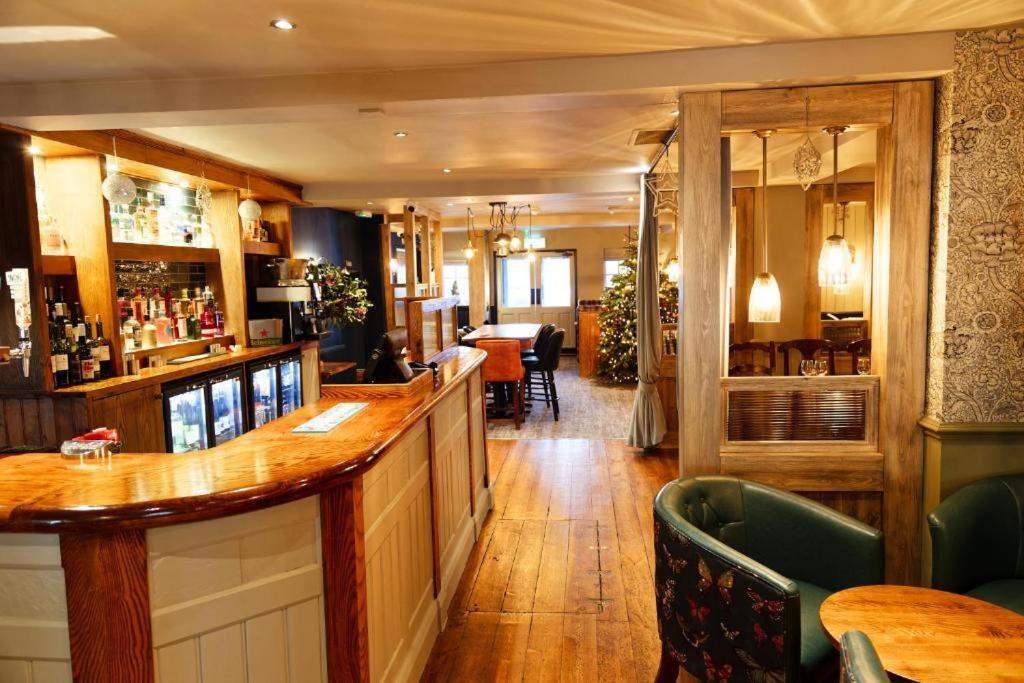 een bar met een houten bar in een restaurant bij Three Horseshoes, Bubbenhall in Bubbenhall