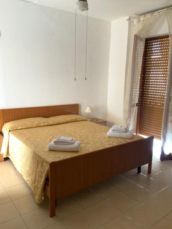 Postel nebo postele na pokoji v ubytování La Scogliera Bed & Breakfast