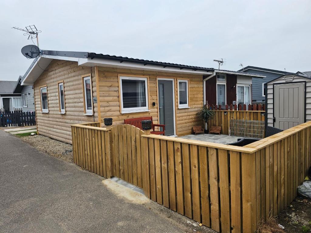 a wooden fence in front of a house at Beautiful & Stunning 1-Bed Chalet in Bridlington in Bridlington