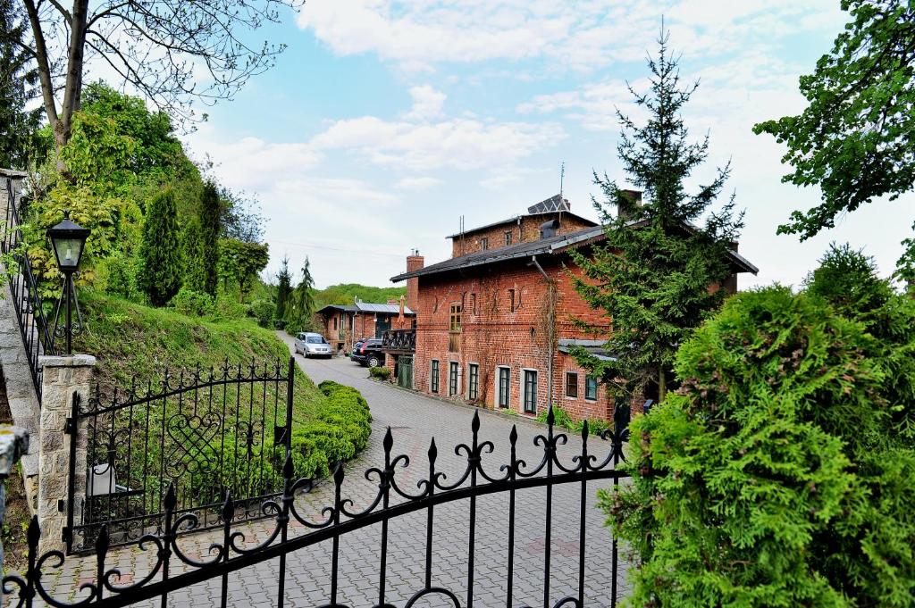 a wrought iron fence in front of a building at Korona in Elblag