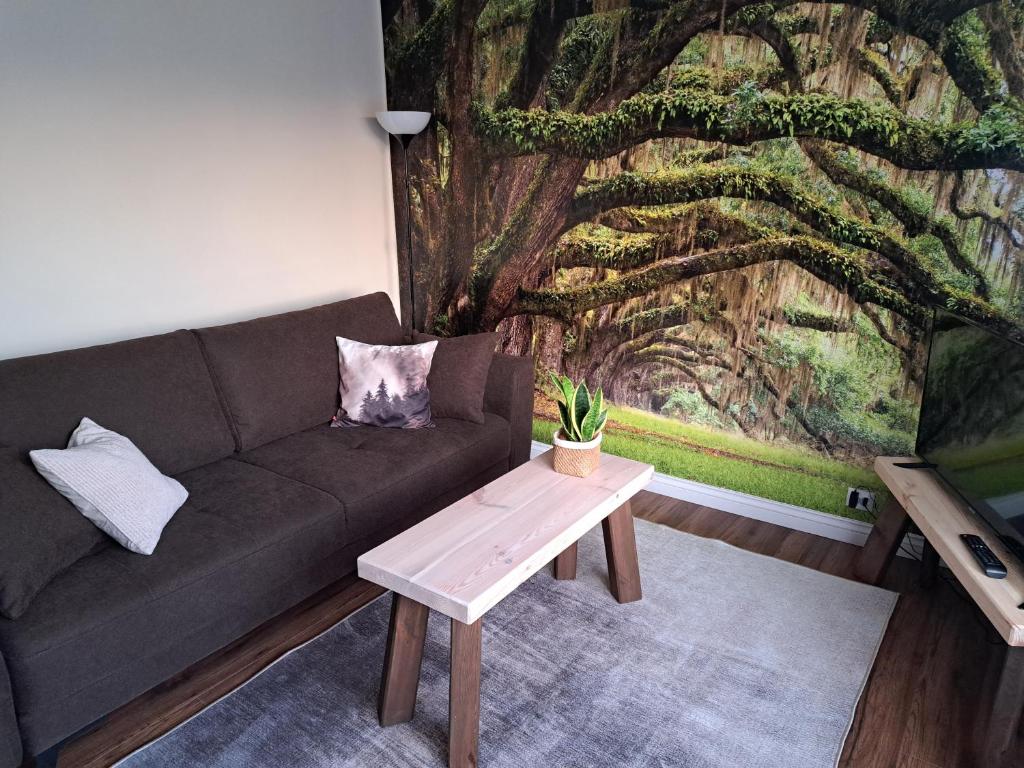 a living room with a couch and a table at Apartament Natura in Lidzbark Warmiński