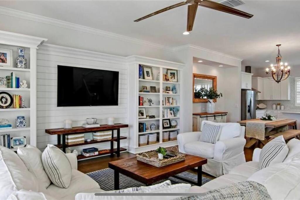 a living room with white furniture and a flat screen tv at Luxurious Modern Townhouse right across beach!! Table Tennis in St. Pete Beach
