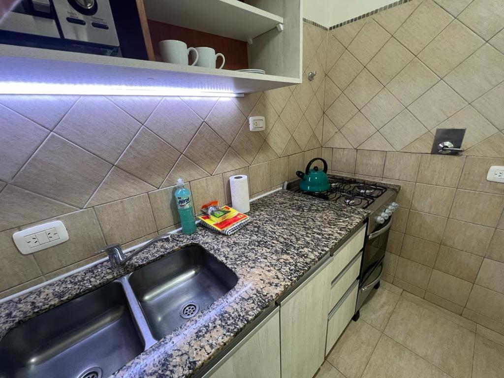 a small kitchen with a sink and a stove at Duplex 2 dormitorios con cochera en Banfield in Banfield