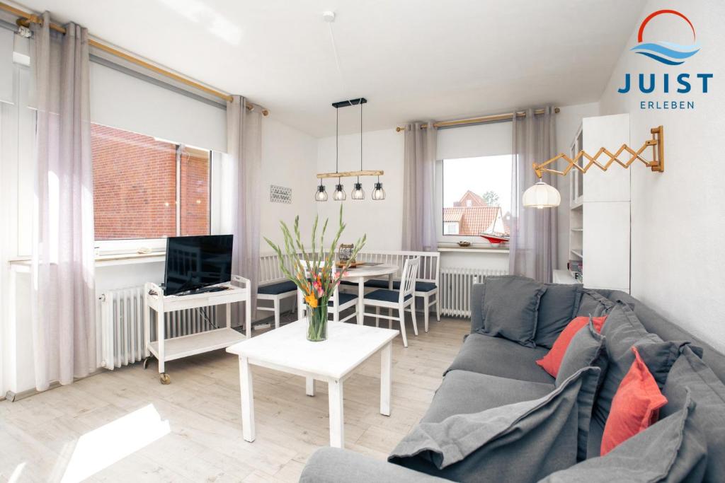 a living room with a couch and a table at Haus Hamburg 181 Wohnung 1 in Juist
