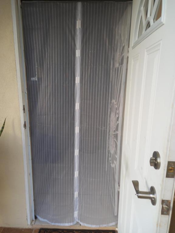 a white door with a metal gate on it at Spring Top Cottage in Falmouth