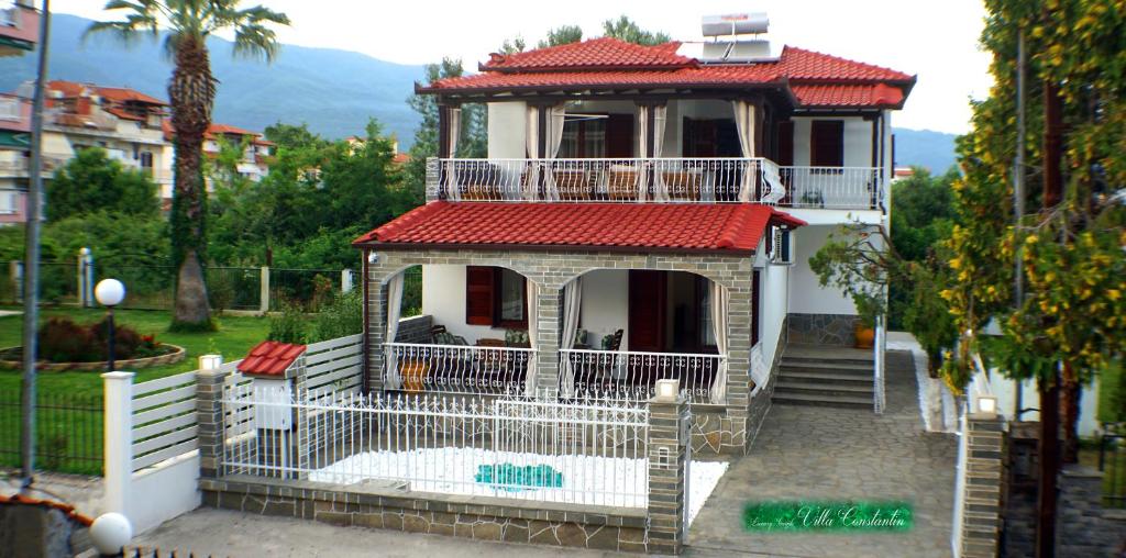 a house with a red roof and a balcony at VILLA KONSTADINE in Asprovalta