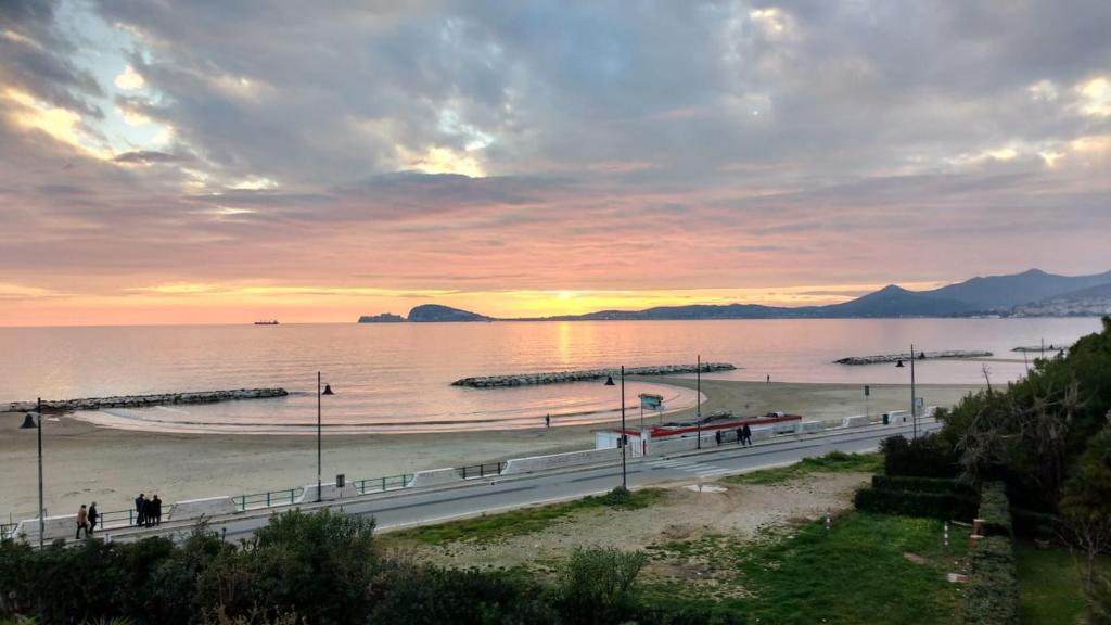 a view of a beach with a sunset in the background at Bordoriva in Formia
