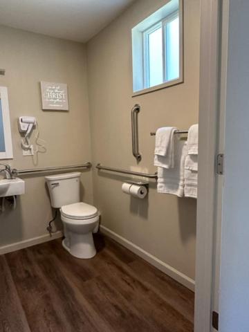 a bathroom with a toilet and a sink and a window at Crater Lake Gateway - Hwy 140 in Klamath Falls