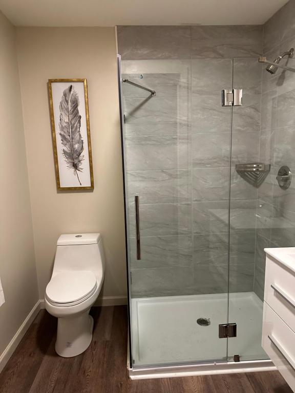 a bathroom with a toilet and a glass shower at Crater Lake Gateway - Hwy 140 in Klamath Falls