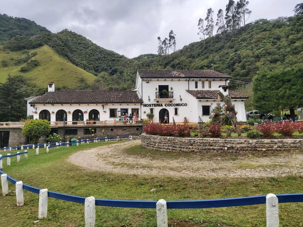 a large white building in front of a mountain at Hotel Coconuco by Destino Pacifico in Coconuco