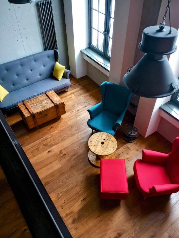 a living room with a couch and chairs and a table at RedCity LOFT 129 in Żyrardów