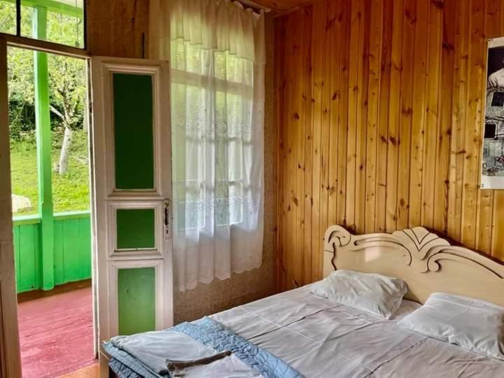 a bedroom with a white bed and a window at Guest House Guliada in Gordi